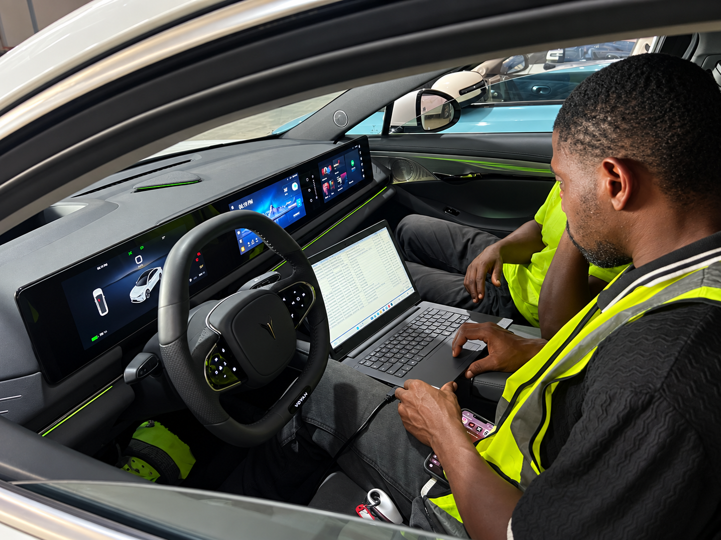 SAGLEV premium electric vehicle interior with panoramic curved display, intelligent cockpit, ambient trim, sustainable upholstery, and steering wheel controls